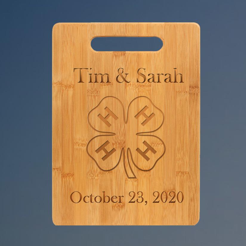 Custom engraved bamboo cutting board with 4-H logo and personalized text.