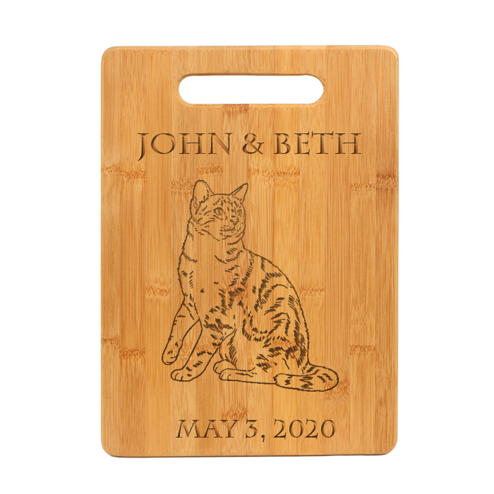 Custom engraved bamboo cutting board with personalized text and cat design.