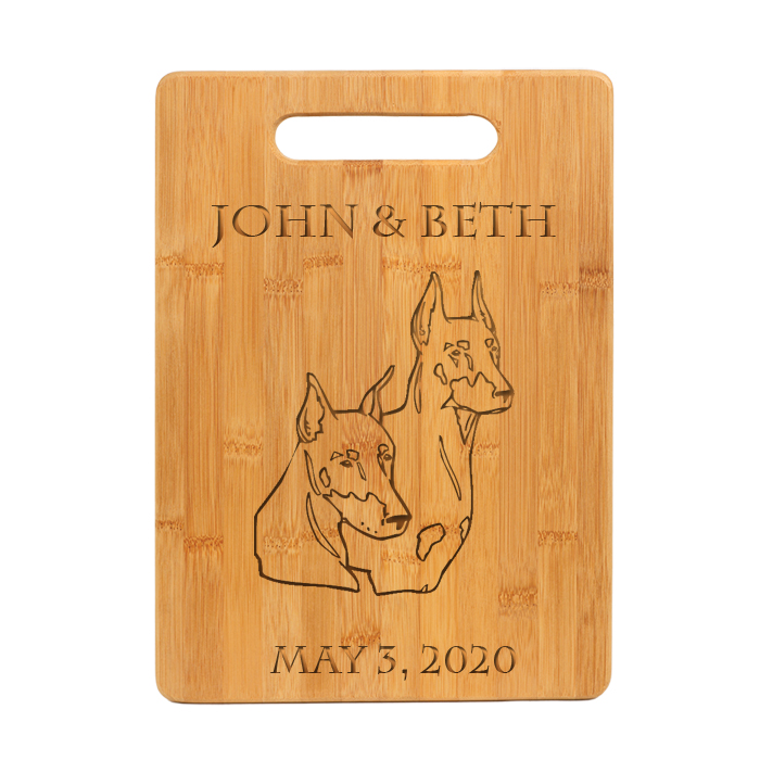 Custom engraved bamboo cutting board with personalized text and Doberman dog design.