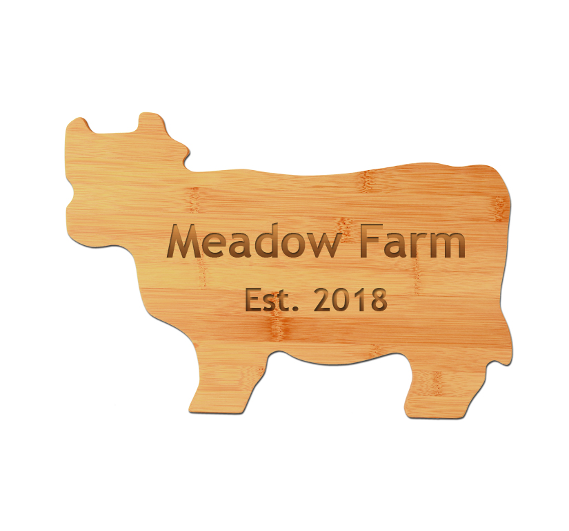 Personalized bamboo cutting board cut out in the shape of a cow comes with engraved text. Cow Cutting Board