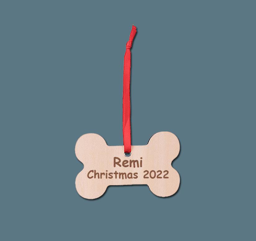 Personalized engraved wood dog bone ornament with engraved text. Dog Bone Ornament