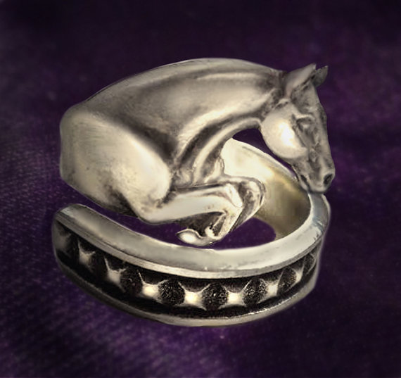 Adjustable pewter jumping horse ring.
