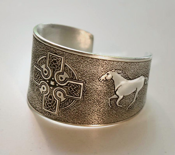 Pewter cuff bracelet with a Celtic cross and a running horse.