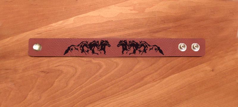 Horse jewelry bracelet made out of leatherette and custom engraved with a decorative horse design. Equestrian Jewelry