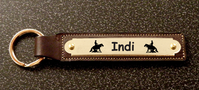 Equestrian leather key fob with brass nameplate and engraved rodeo design. Rodeo Key Fob