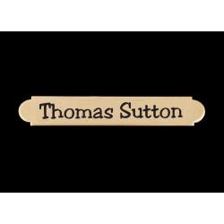 Engraved brass adhesive back nameplate with personalized text.
