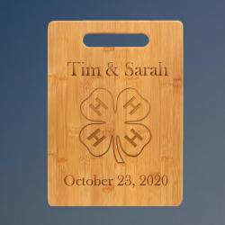 Custom engraved bamboo cutting board with 4-H logo and personalized text.