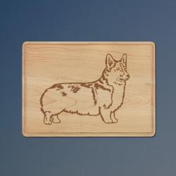 Personalized drip ring maple cutting board with a corgi design and custom engraved text.