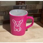 Pink ceramic round coffee mug with a sitting corgi engraved on the front. Corgi Mug