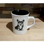 White ceramic round coffee mug with a sitting corgi engraved on the front. Corgi Mug